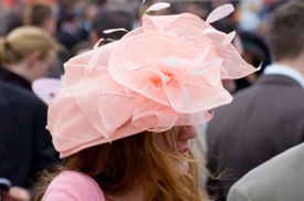 Feathered Hat Wearing a feathered hat at a horse racing event